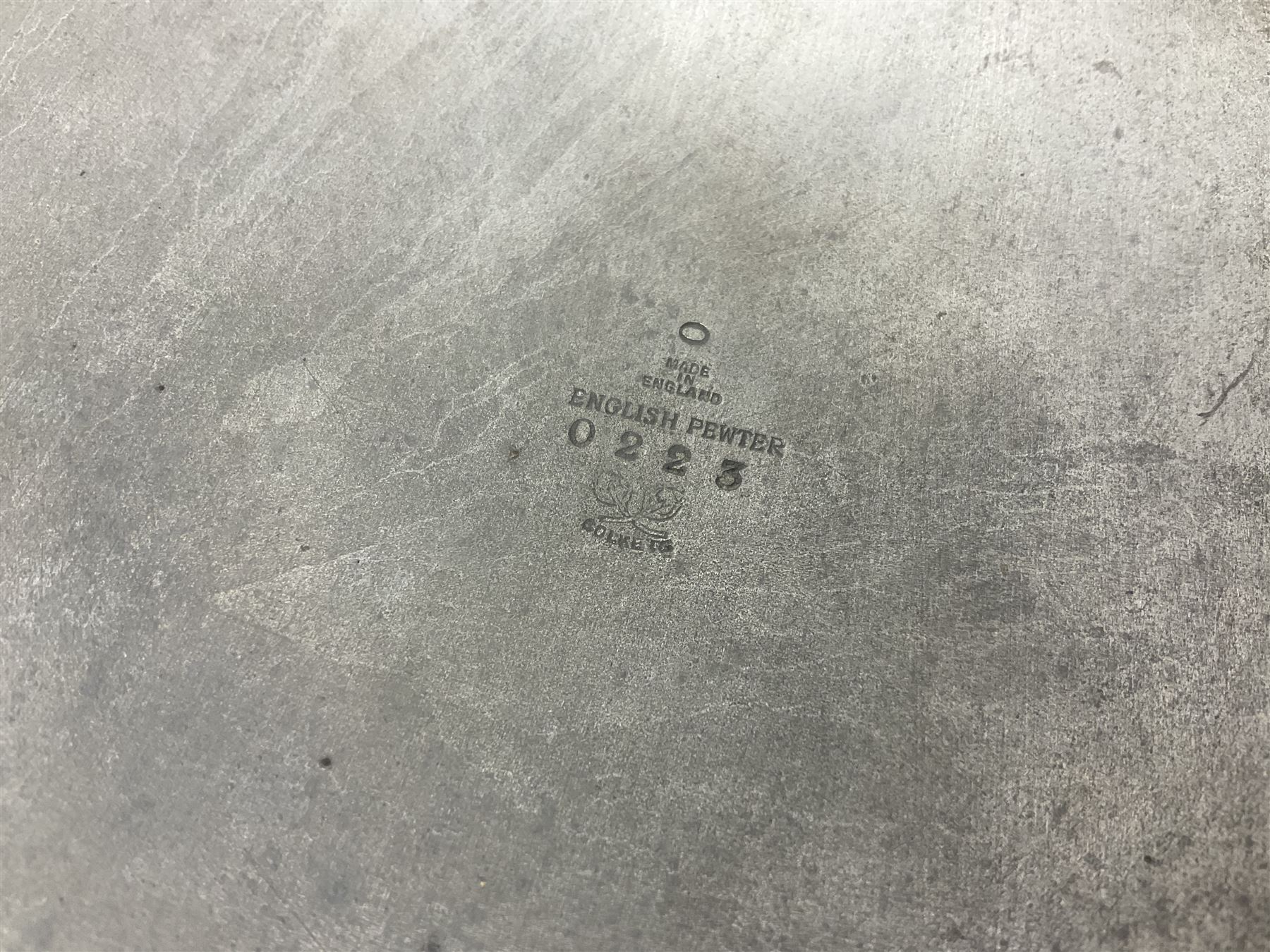 Pair of Solkets English pewter candlesticks, the bud shaped sockets raised upon three angular fin supports and a slightly domed circular base with cast stylised foliate decoration, H23cm