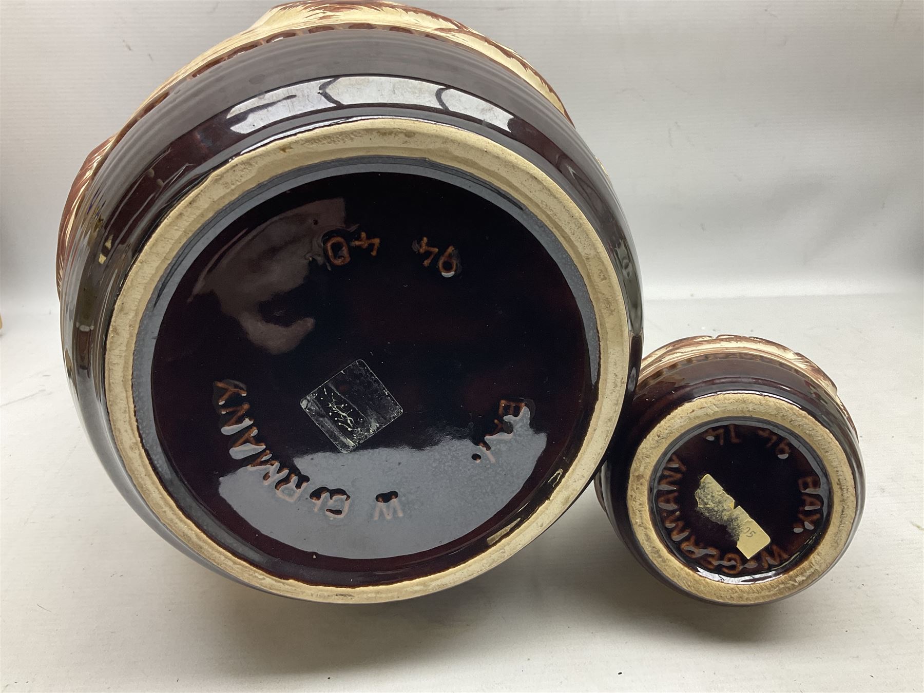 Pair of Bay West German vases, with bold moulded flower and foliage decoration in green, orange and ochre on brown ground, largest H40cm