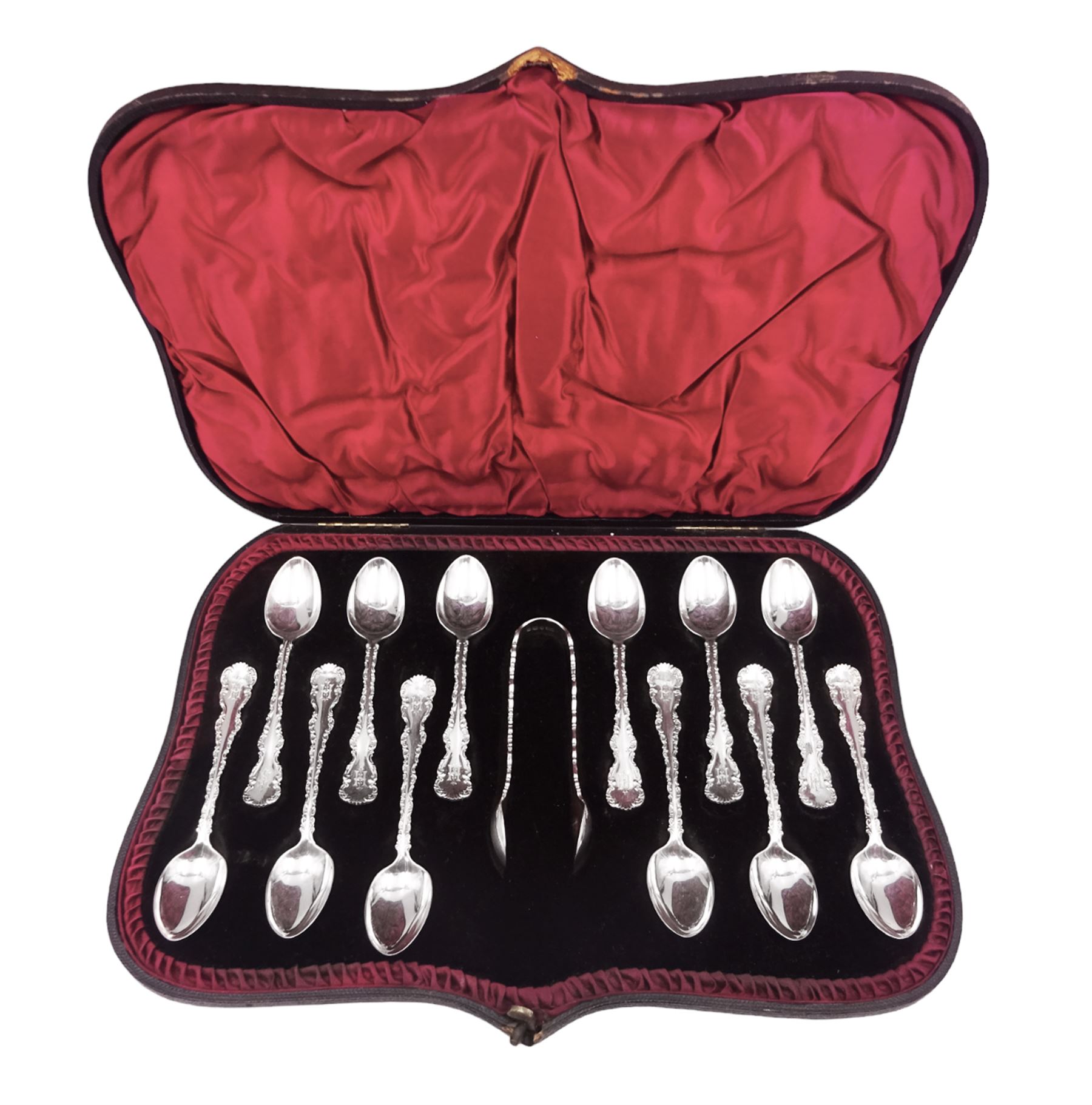 Set of ten Victorian silver coffee spoons, each with shaped scroll design rim, and a matching pair of sugar tongs, hallmarked Lee & Wigfull, Sheffield 1897, in tooled leather burgundy velvet and silk lined fitted case 