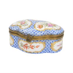 Two 19th century porcelain trinket boxes, comprising blue and white Delft example with courting scene to cover and a Meissen style example, hand painted with floral sprays on a blue scale ground, tallest H4.5cm 