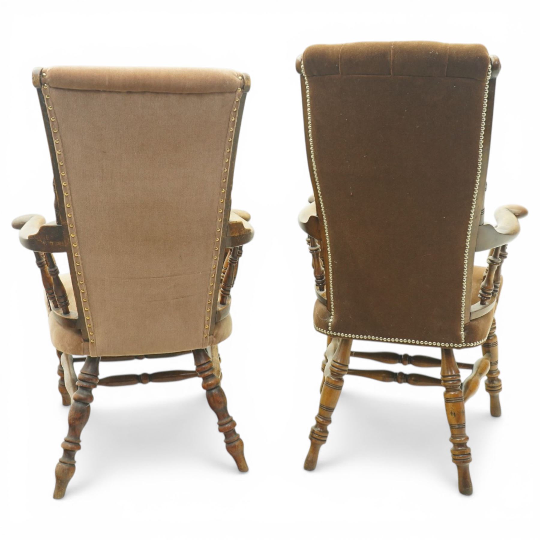 Near pair of late 20th century oak high back armchair, upholstered in brown fabric with buttoned back and close-nailed borders, shaped arms on turned supports, over a stuff-over seat, raised on turned legs united by stretchers