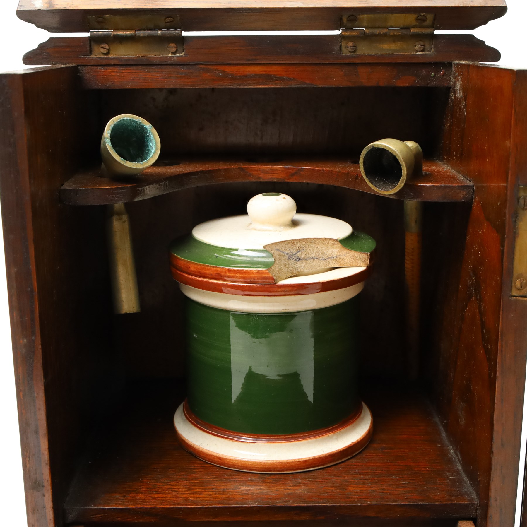 Edwardian oak smokers cabinet with carved panel door and hinged lid and a collection of various pipes and other items