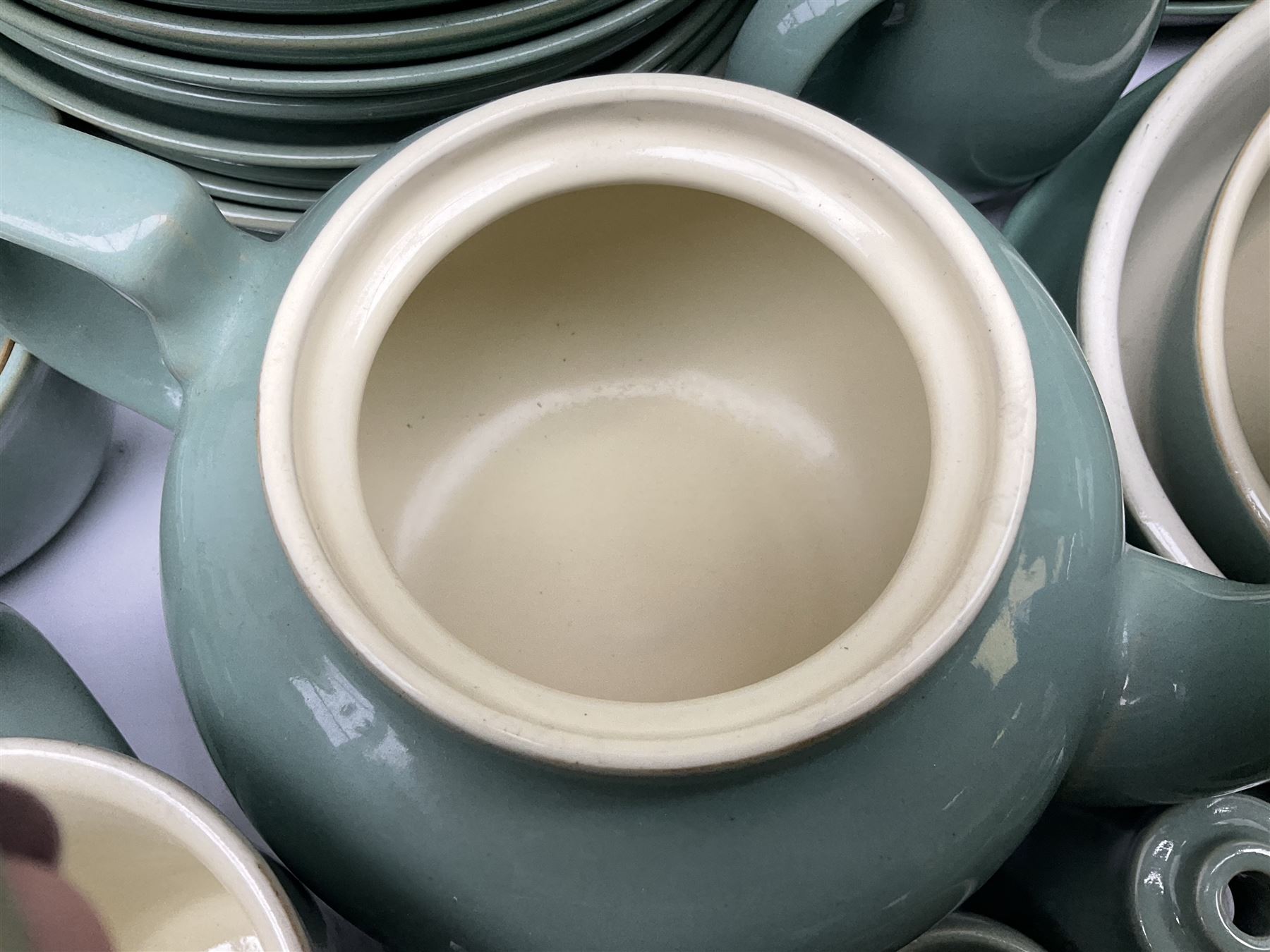Denby Manor Green pattern part tea and dinner service, to include seven dinner plates, thirteen side plates, ten dessert plates, two oval dishes of various sizes, four cups and saucers, seven bowls with covers, two teapots etc (74)  