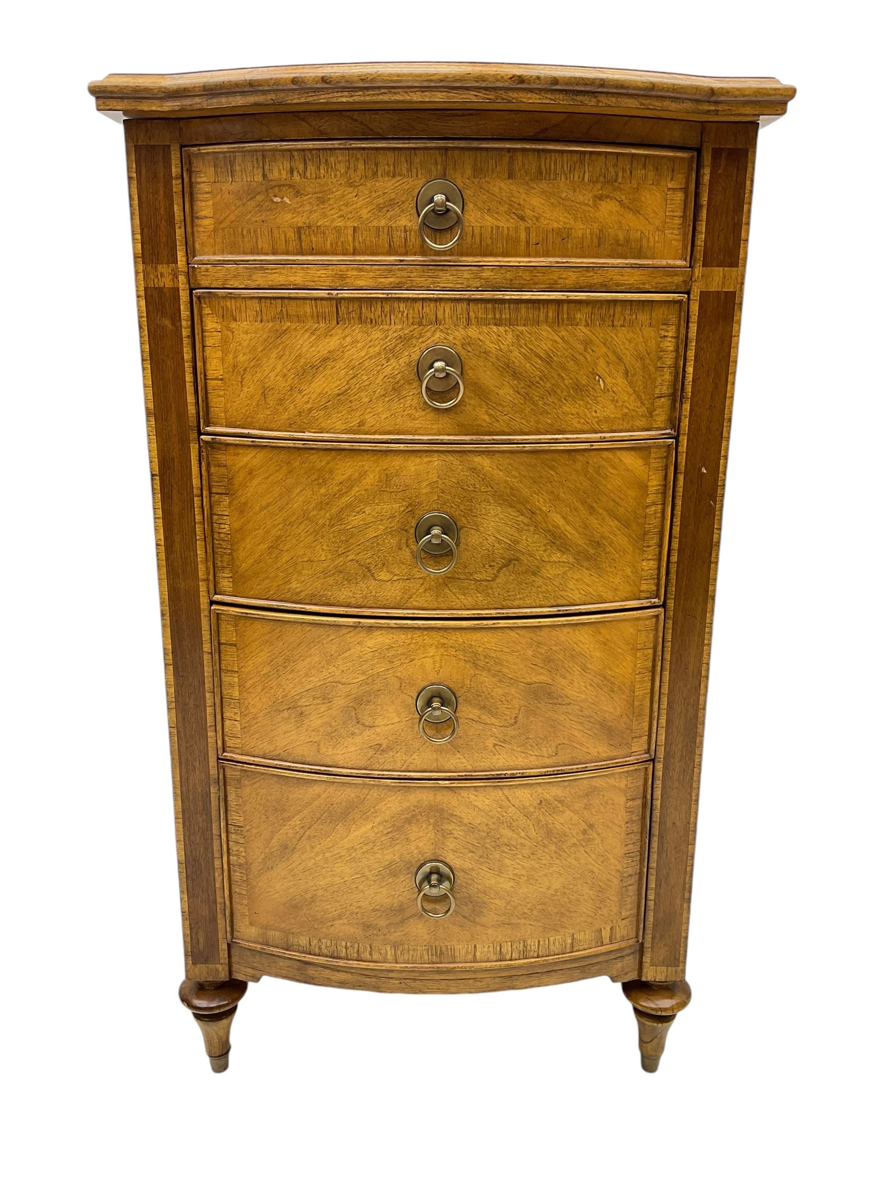 Frank Hudson - mid-20th century Mindi ash and burr walnut bow-fronted lingerie chest, crossbanded hinged top concealing vanity mirror, over five graduated cockbeaded drawers, raised on turned supports