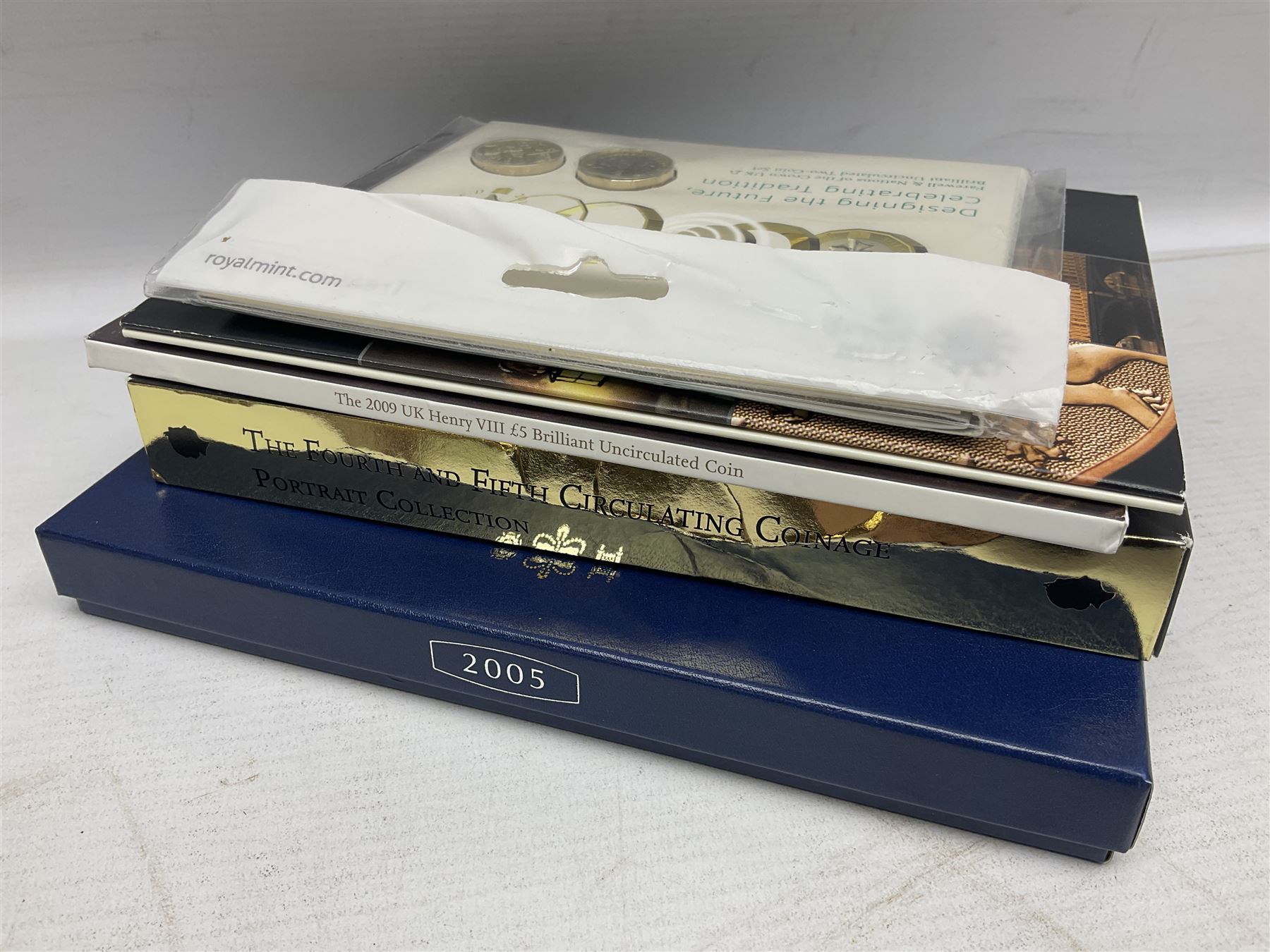 The Royal Mint United Kingdom 2005 proof coin set, with certificate, 2009 'Henry VIII' brilliant uncirculated fine pound coin, 2010 brilliant uncirculated coin collection, 2015 'The Fourth and Fifth Circulating Coinage Portrait Collection', and 'Farewell and Nations of the Crown UK' one pound brilliant uncirculated two coin set, all cased or in card folders