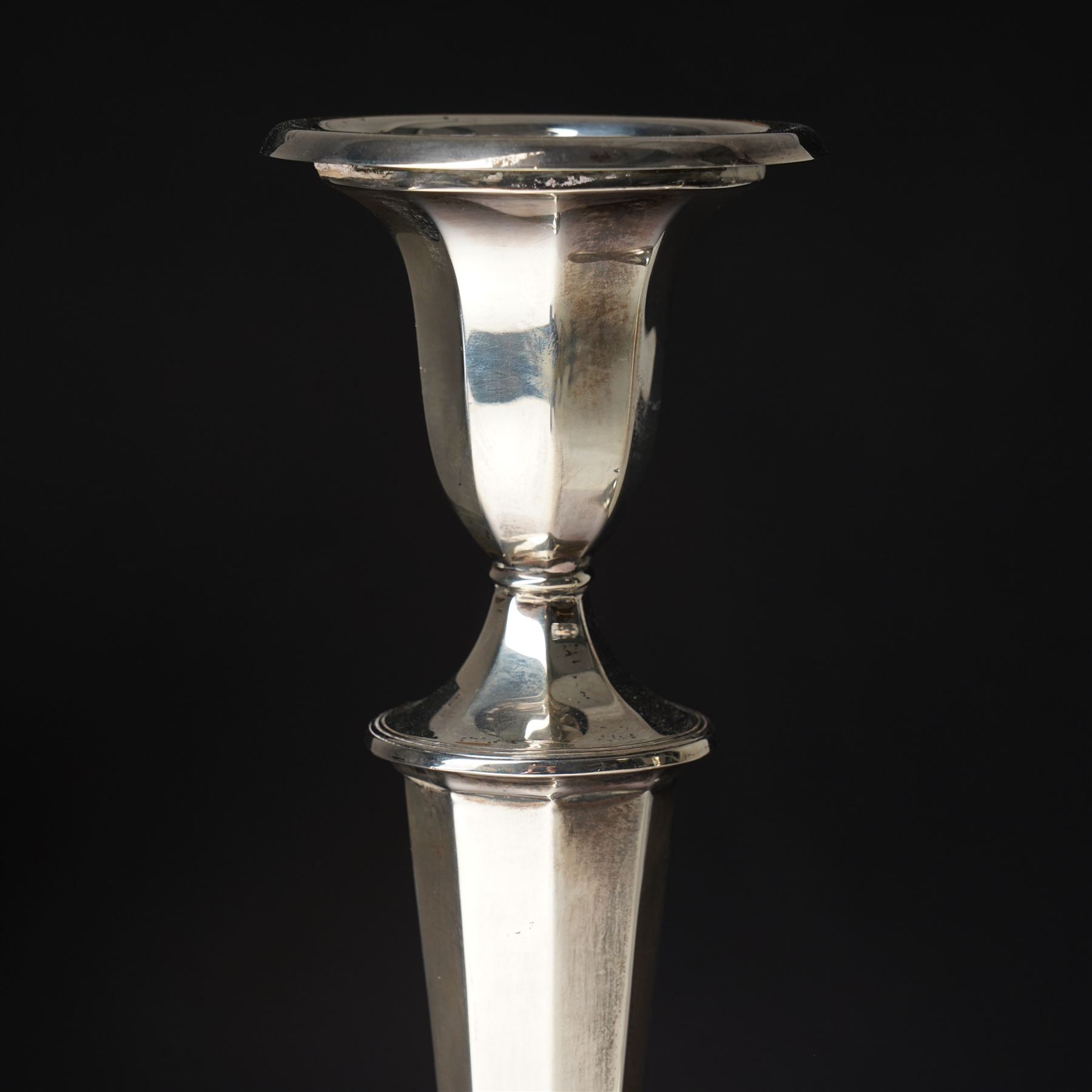 Pair of silver candlesticks with octagonal tapering stems and circular weighted bases H30cm Sheffield 1923 Maker Hawksworth Eyre & Co Ltd