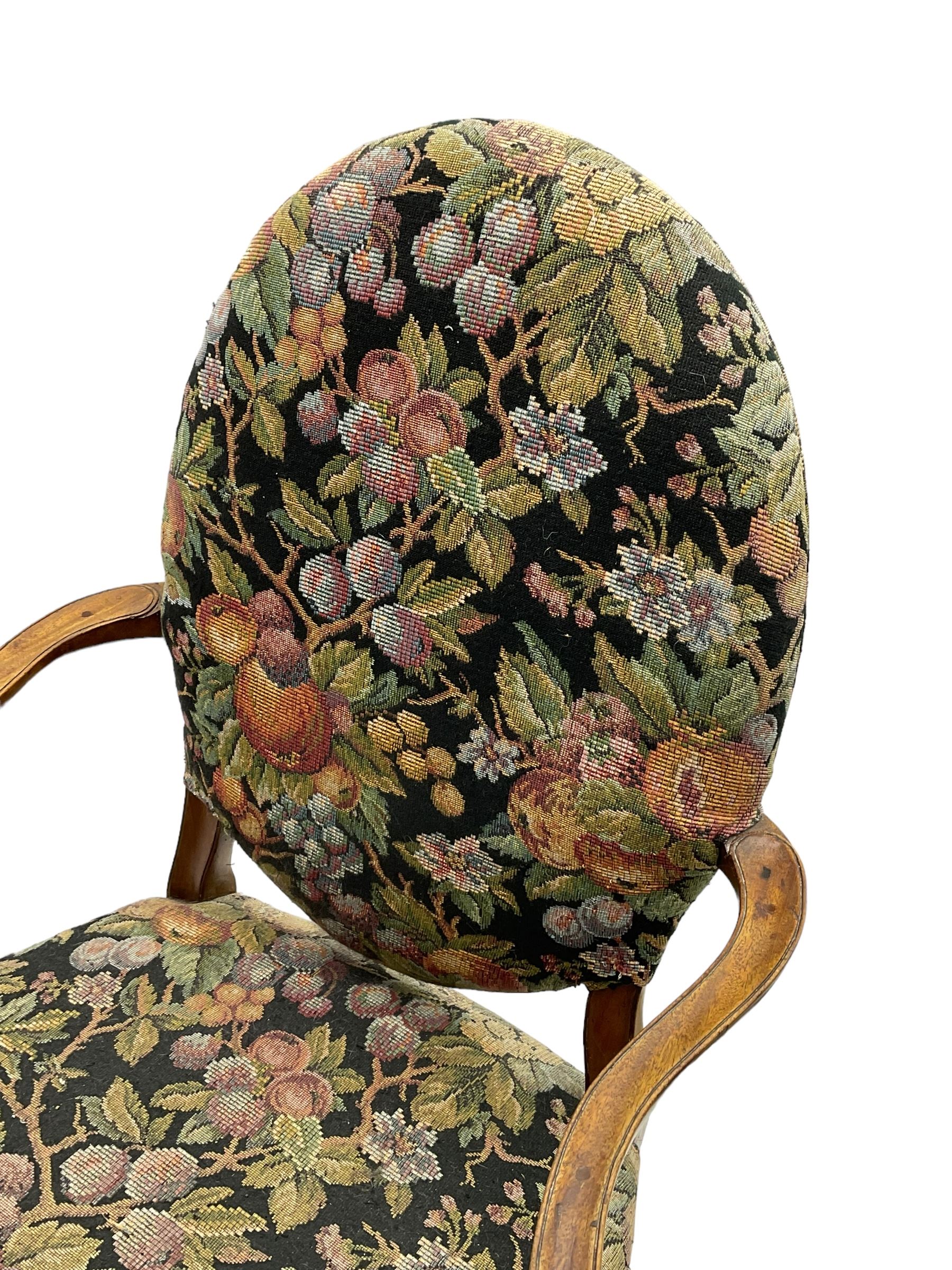 Pair of George III mahogany framed open armchairs, oval back and serpentine seat upholstered in fruit and foliage patterned fabric, shaped and moulded arms and arm supports, on square tapering moulded front supports 