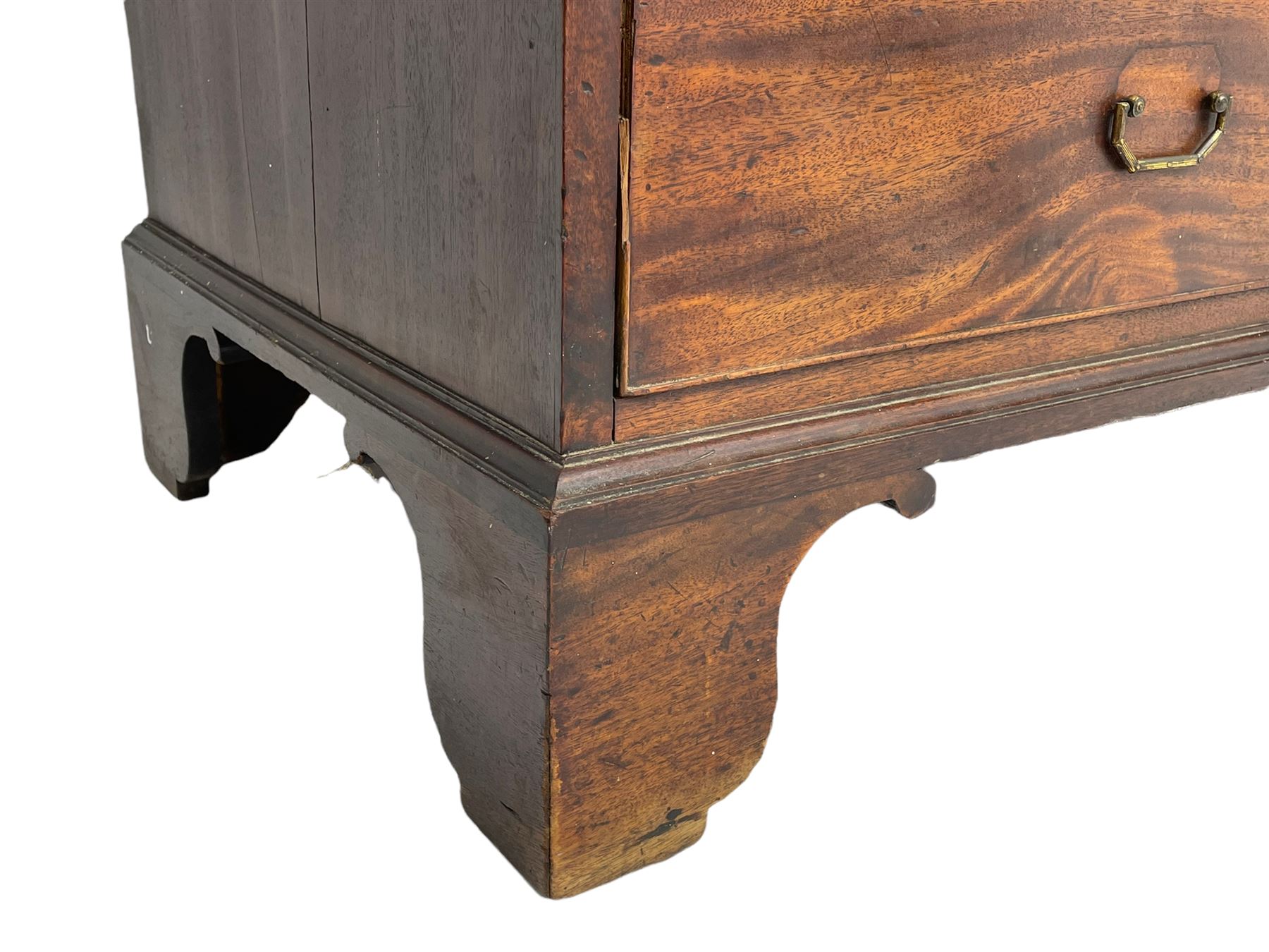George III mahogany linen press, projecting cornice over two figured doors enclosing five linen slides, the lower section fitted with two short and two long drawers, on bracket feet