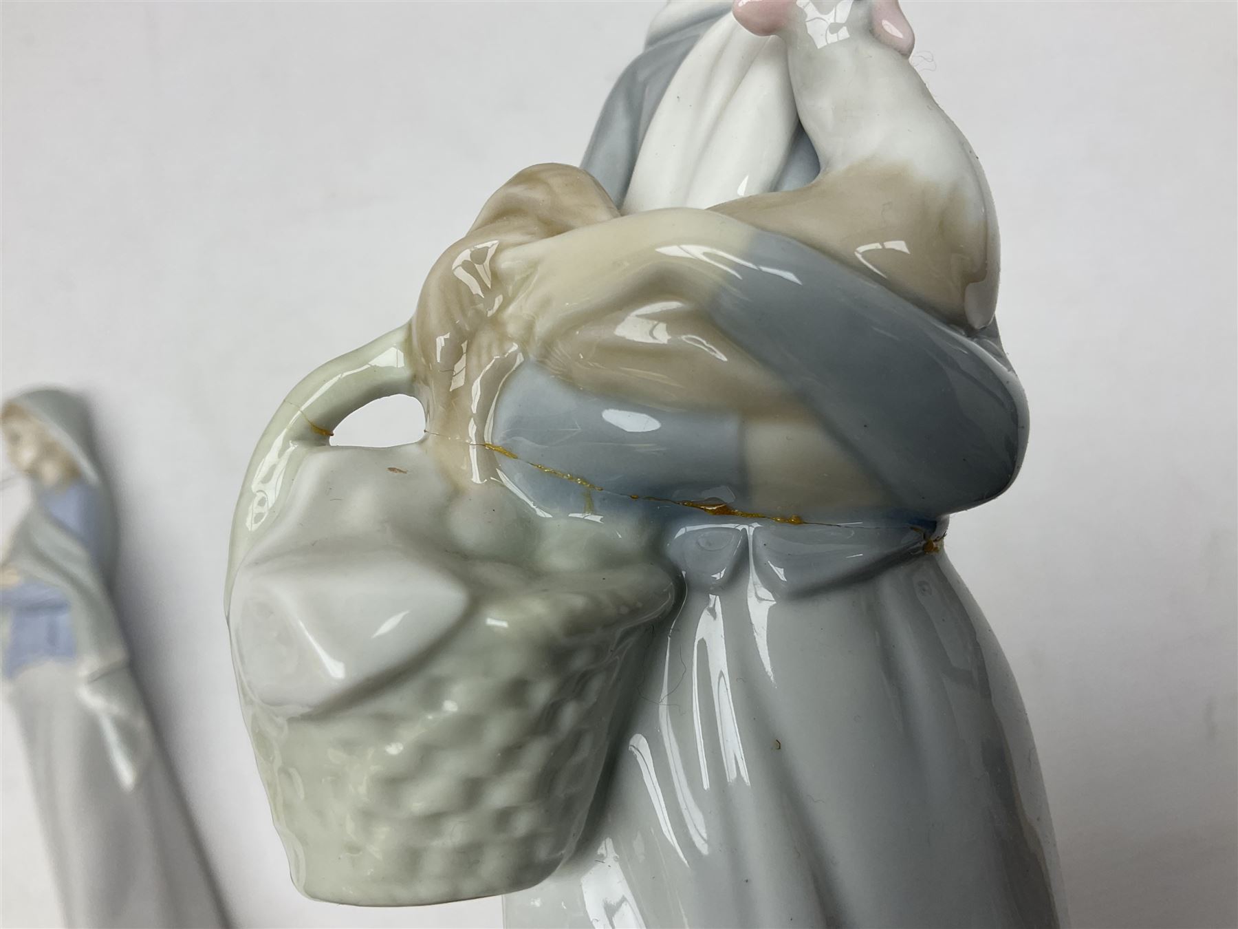 Four Lladro figures, including Girl With Cockerel no 4591, Gres Lonely no 2076 etc together with Nao figure 