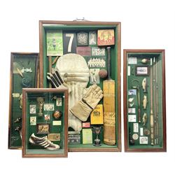 Four framed sporting memorabilia displays, the largest example containing 1930s cricket memorabilia, together with two fishing displays and a football display, each within wooden glazed frames, largest H105cm
