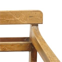 Early 20th century pine chapel bench, with moulded plank back rail over plain rail, with book storage to the back, open shaped end supports with curved arms, turned front uprights, plank seats, square legs united by low stretchers