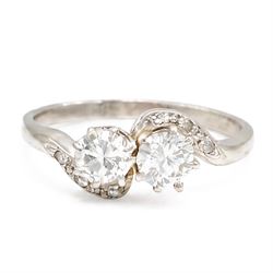 Platinum diamond crossover ring, set with two round brilliant cut diamonds and diamond set...