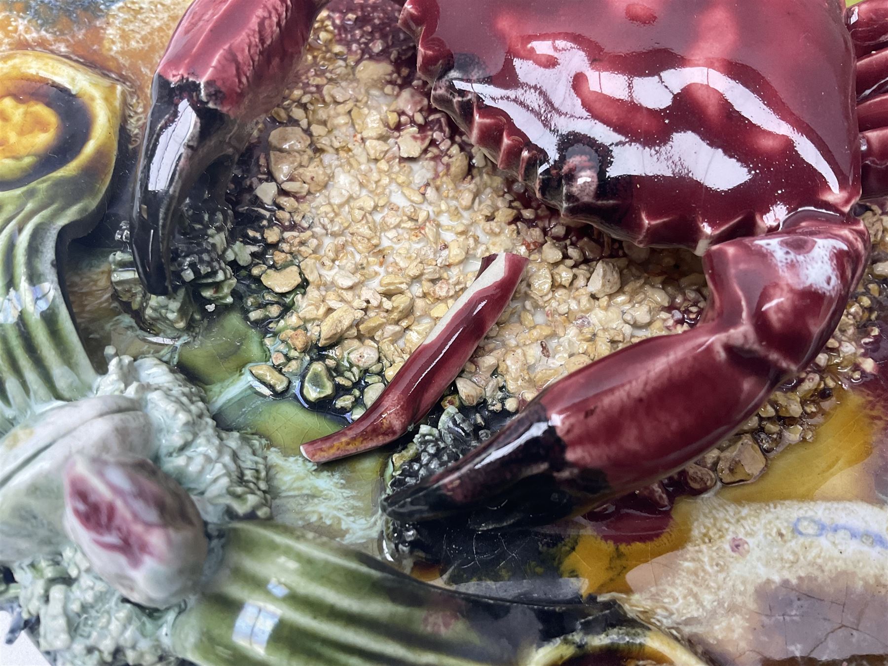 Five 20th Century Portuguese Palissy style Majolica wall plates, all depicting crustaceans to the centre modelled in relief surrounded by encrustations and shells, both with impress marks beneath, largest D29cm