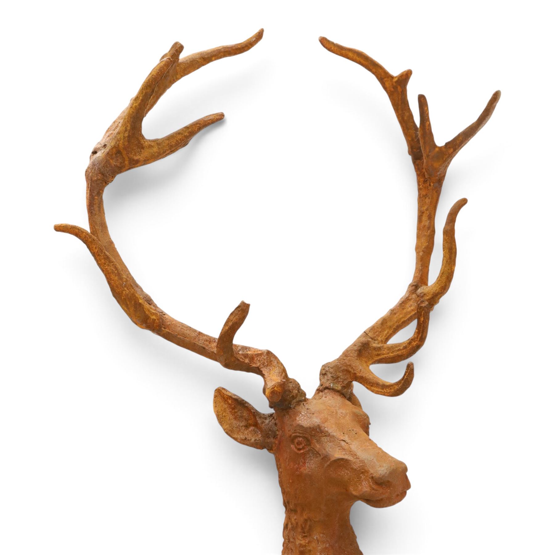 Pair of cast iron stags, upon a on moulded rocky plinth, standing alert 