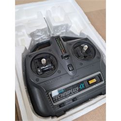 Tamiya 'The Grasshopper' 1:10 scale remote control car, boxed, together with an Acombs Techniplus-a controller, both boxed