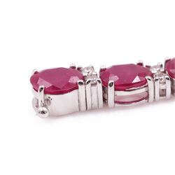 18ct white gold ruby and diamond bracelet, twenty-six oval cut rubies, each spaced by two round brilliant cut diamonds, stamped 750, total ruby weight 12.70 carat, total diamond weight 0.46 carat