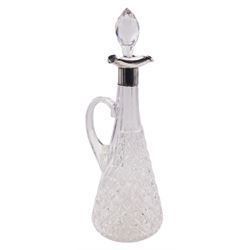 Late Victorian silver mounted glass claret jug, the tapering cylindrical body with diamond cut decoration, curved handle, and silver mounted neck and collar curved to form three lips, with faceted spire stopper, hallmarked Birmingham 1900, makers mark T W & S, H34cm