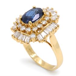 18ct gold sapphire and diamond cluster ring, single oval cut sapphire of approx 2.05 carat, surrounded by two rows of round brilliant cut and baguette cut diamonds, Sheffield import mark 1994, total round cut diamond weight approx 0.55 carat