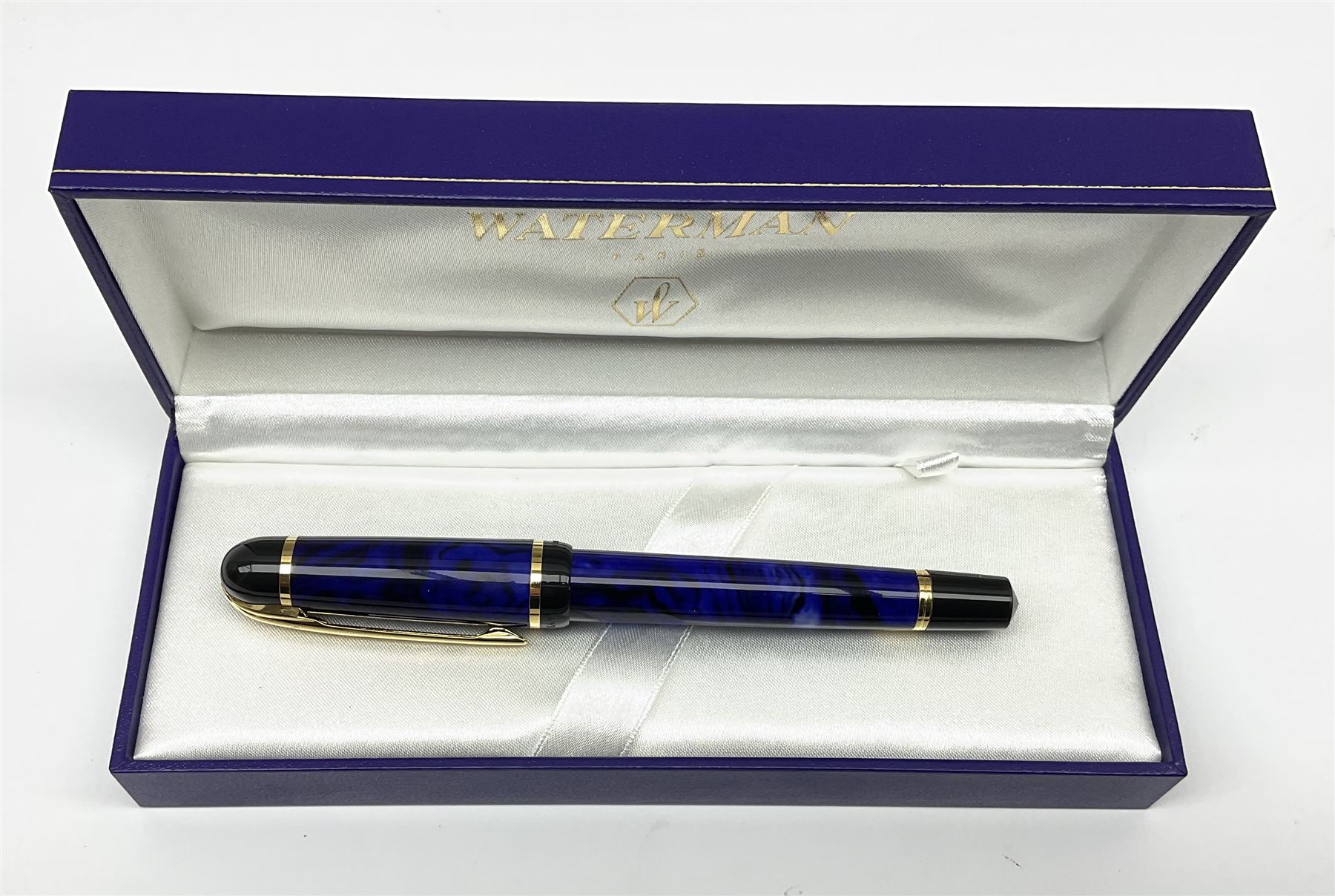 A Waterman Phileas fountain pen, with blue marbled effect body and gold coloured clip and banding, with makers fitted blue leather box, and outer card sleeve. 