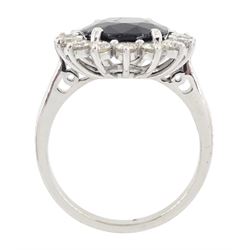 18ct white gold sapphire and diamond cluster ring, single oval cut sapphire of 4.33 carat, with round brilliant cut diamond surround, stamped 750, total diamond weight 0.72 carat