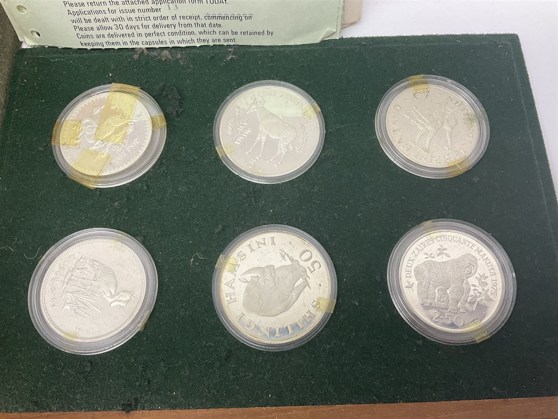The Royal Mint 'Conservation Coin Collection' formed of twenty-four silver proof coins, housed in the wooden display case, with information booklet