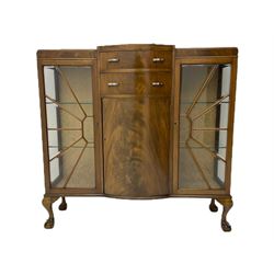 Mid-20th century Art Deco style walnut display cabinet, two central drawers over cupboard flanked by two bevel glazed display cabinets with sunburst astragal glazing, on ball and claw cabriole feet