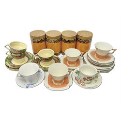 Four Portmeirion storage jars with Greek key pattern on an orange ground, together with Tams Ware tea service and other ceramics