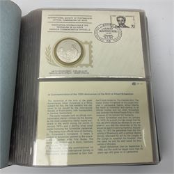 Thirty-one 'International Society of Postmasters Official Commemorative Issues' sterling silver proof medallic covers dating from 1975 to1977, housed in the official folder and a 'Commemorating The Bicentennial Of The United States Of America' sterling silver proof medallic first day cover in blue wallet