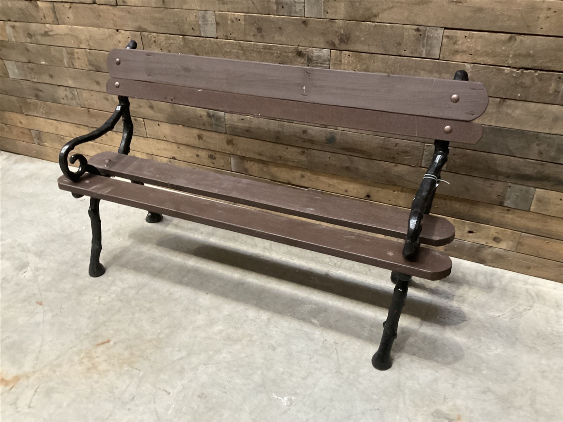 20th century tree cast iron and timber slatted garden bench, black painted frame with stained wood