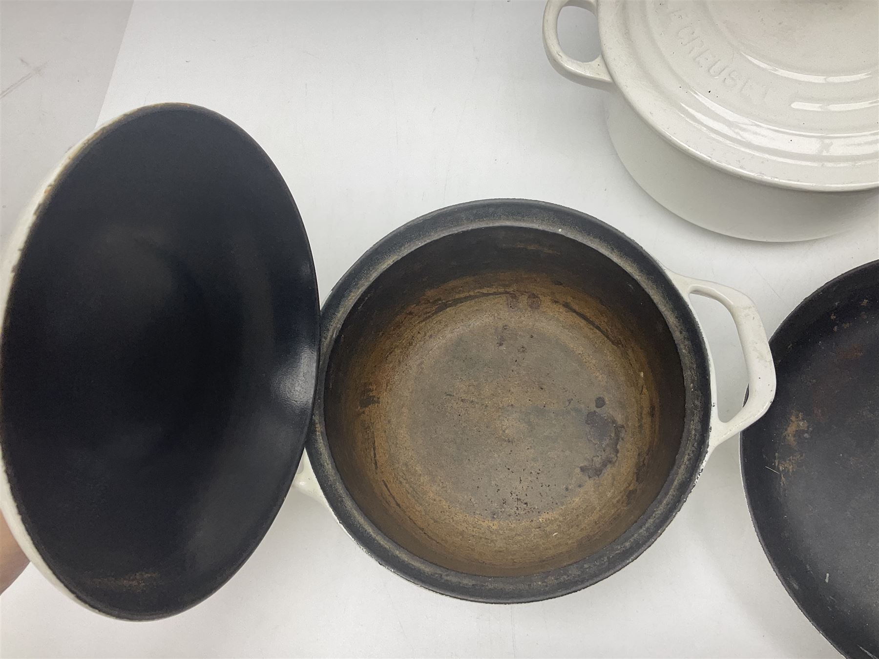 Le Creuset cast iron casserole dish, together with two Waterford cast iron dishes and a frying pan