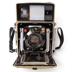 Linhof Tecnika 70 medium format press camera serial no. 1711919, with a Xenotar 1:2.8/80 lens serial no. 9254350 and a Symmar 1:5.6/180 lens serial no. 8357904, both coupled to the camera, and additional accessories including Symmar-S 5.6/100 lens, and a Carl Zeiss Jena Apo-Lanthar 40mm1:4.5 macrolens, numbered set of seven Linhof dark slides, super rollex roll film holder and anatomical grip, all contained within modern case