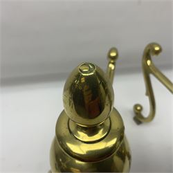 Pair of early 20th century brass fire dogs, each with sphere and urn finial, upon a scrolling base, H38cm