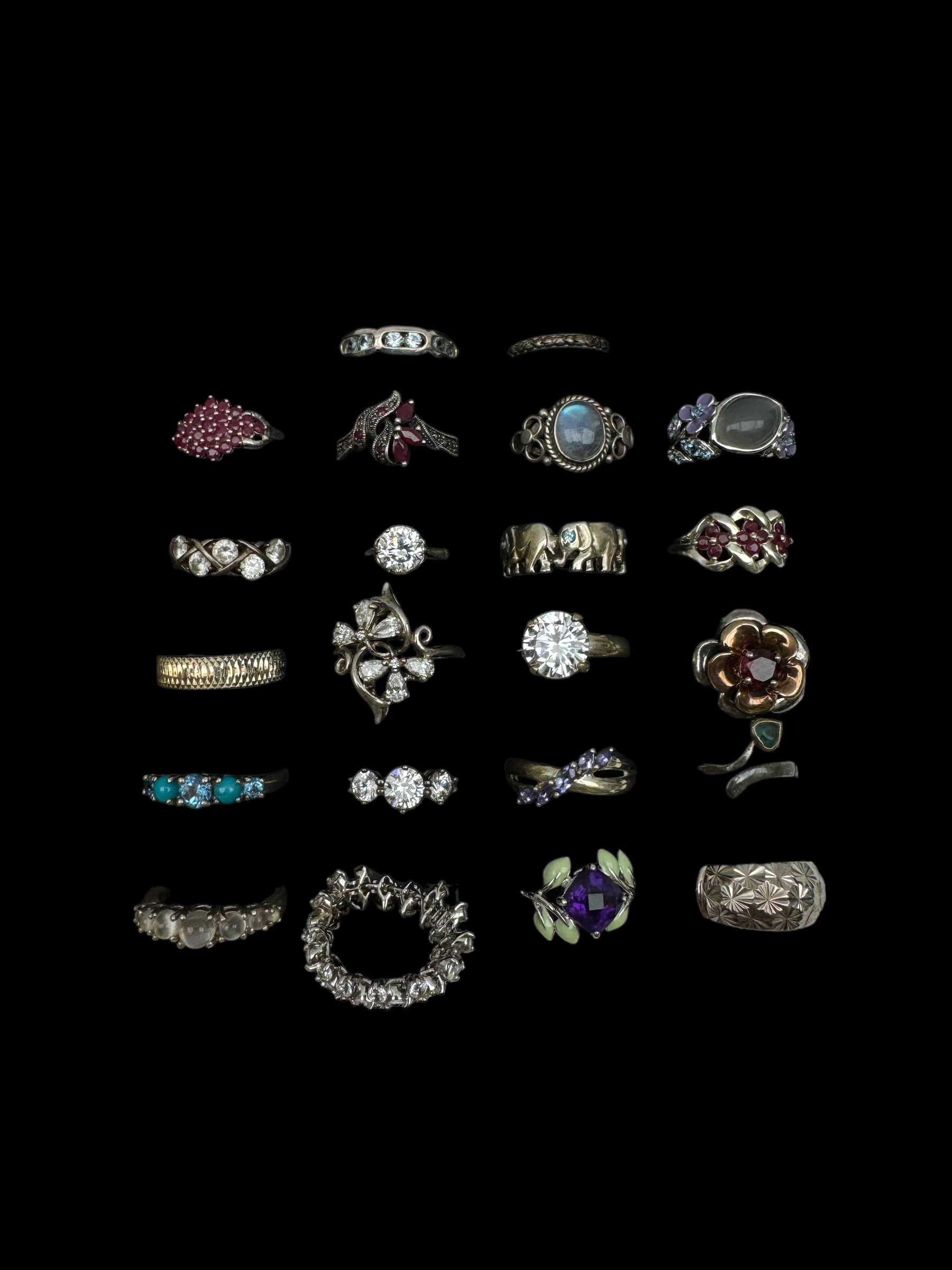 Twenty-two silver and stone set silver rings including turquoise, garnet, cubic zirconia, moonstone, topaz, tanzanite and amethyst, stamped 925