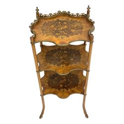 Late 19th century French inlaid Kingwood and walnut étagère, three shaped tiers, the top tier with ornate gilt cast metal gallery and finials, each inlaid with flowers in scrolling foliate surround, splayed hoof supports 