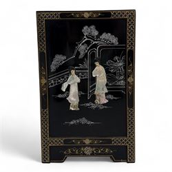 20th century Japanese Shibayama style black lacquered cabinet, rectangular form decorated with mother-of-pearl and hardstone figural inlay, the top with four standing figures, single frieze drawer above two cupboard doors, gilt painted borders and landscape