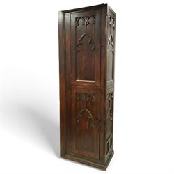 19th century Gothic Revival oak Sacristy vestment cupboard of tall proportions, fitted with two ecclesiastical trefoil moulded panelled doors enclosing four shelves, flanked by a chamfered corner, the side panelled and moulded with matching sacristic architectural mouldings, on skirted base