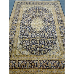  Persian Kashan rug, overall geometric design, blue ground field decorated with stylised Herati motifs, repeating border, 320cm x 216cm  
