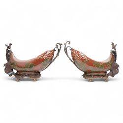Pair of Continental ceramic and patinated metal table centre pieces, possibly by Castilian, each of boat form with pierced and polychrome decoration, with swan and shell moulded supports, H31cm x L46cm