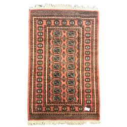Tekke Bokhara peach ground rug, decorated with two rows of Gul motifs, repeating borders decorated with stylised plant motifs