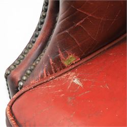 Georgian design wingback armchair upholstered in oxblood leather, the deep button upholstered back with shaped wings and out-scrolled arms, close nailhead trim to the edges, over a loose seat cushion, raised on cabriole front supports terminating in claw and ball feet