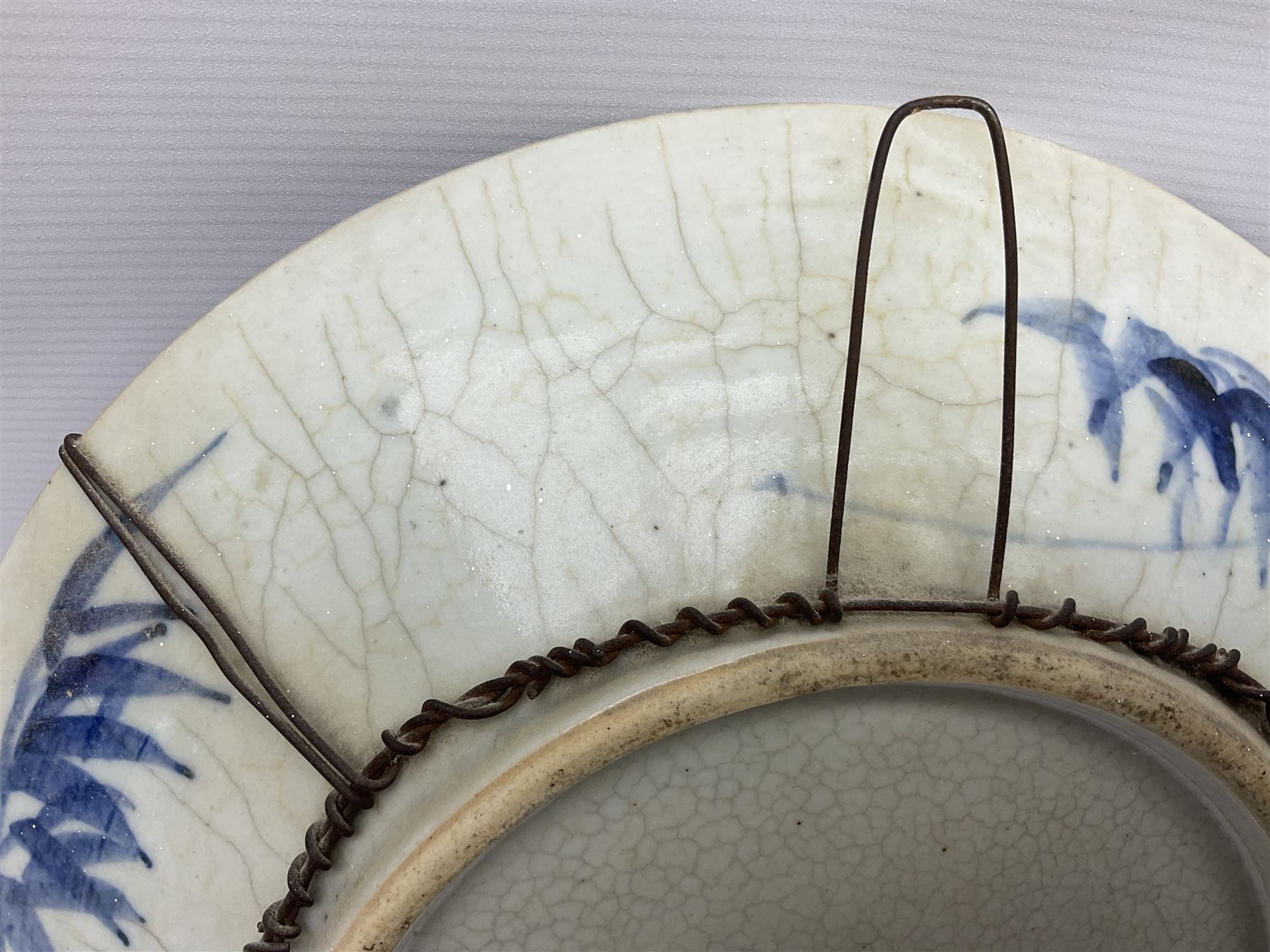 20th century Chinese blue and white crackle glaze charger, decorated with peonies, prunus blossom, and rockwork, within simulated bronze border, with character mark verso, D34cm