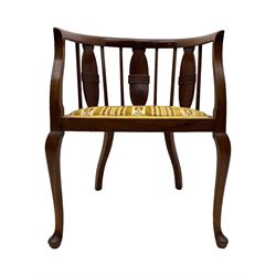 Late Victorian mahogany framed tub chair, rounded backrest with vertical splats and three carved oval medallions, upholstered seat in yellow patterned fabric, on cabriole supports