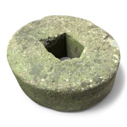 Collection of cast stone garden objects including mill stone, trough, planter, and faces