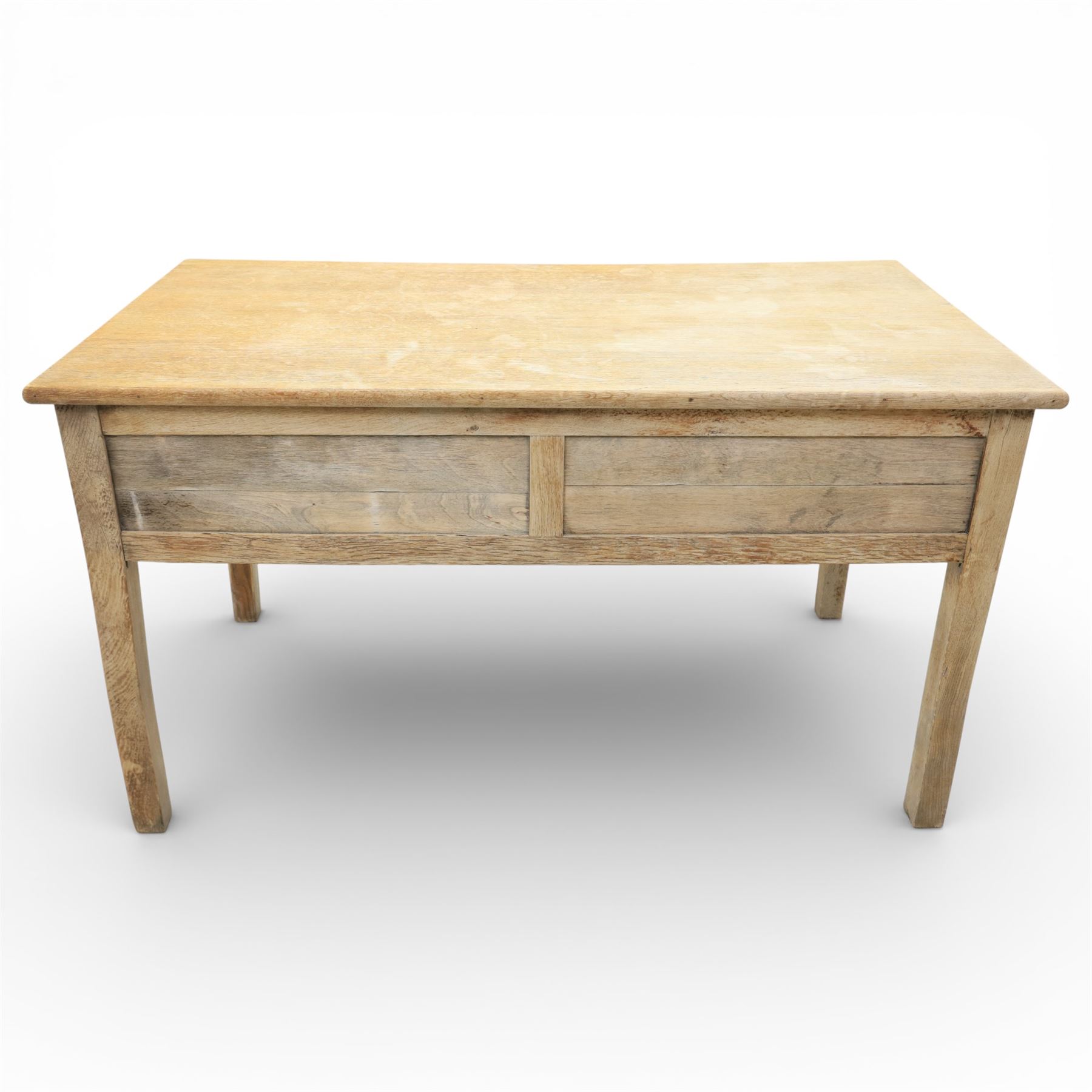 20th century oak kneehole desk, the rectangular top above central drawer and kneehole, flanked by short banks of two drawers, each fitted with brass drop handles, raised upon four plain slightly tapering legs, 75.5cm x 135cm x 73.5cm