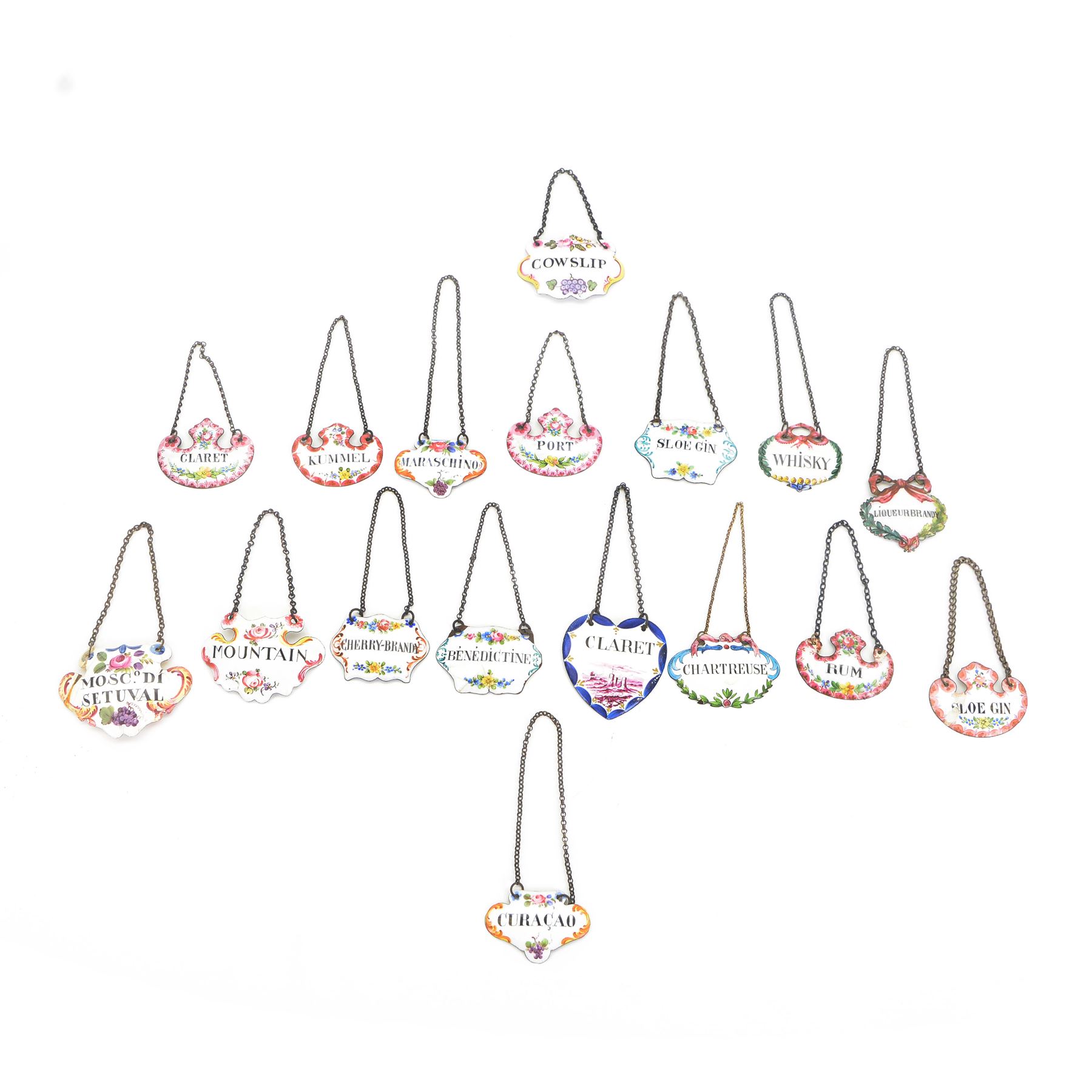 Seventeen mid 18th century and later enamel wine labels, one example of heart shaped form, the rest of cartouche and escutcheon form, various titles including Claret, Rum, Sloe Gin, Port, Whisky, Cowslip, Cherry-Brandy, etc., largest example W7cm 