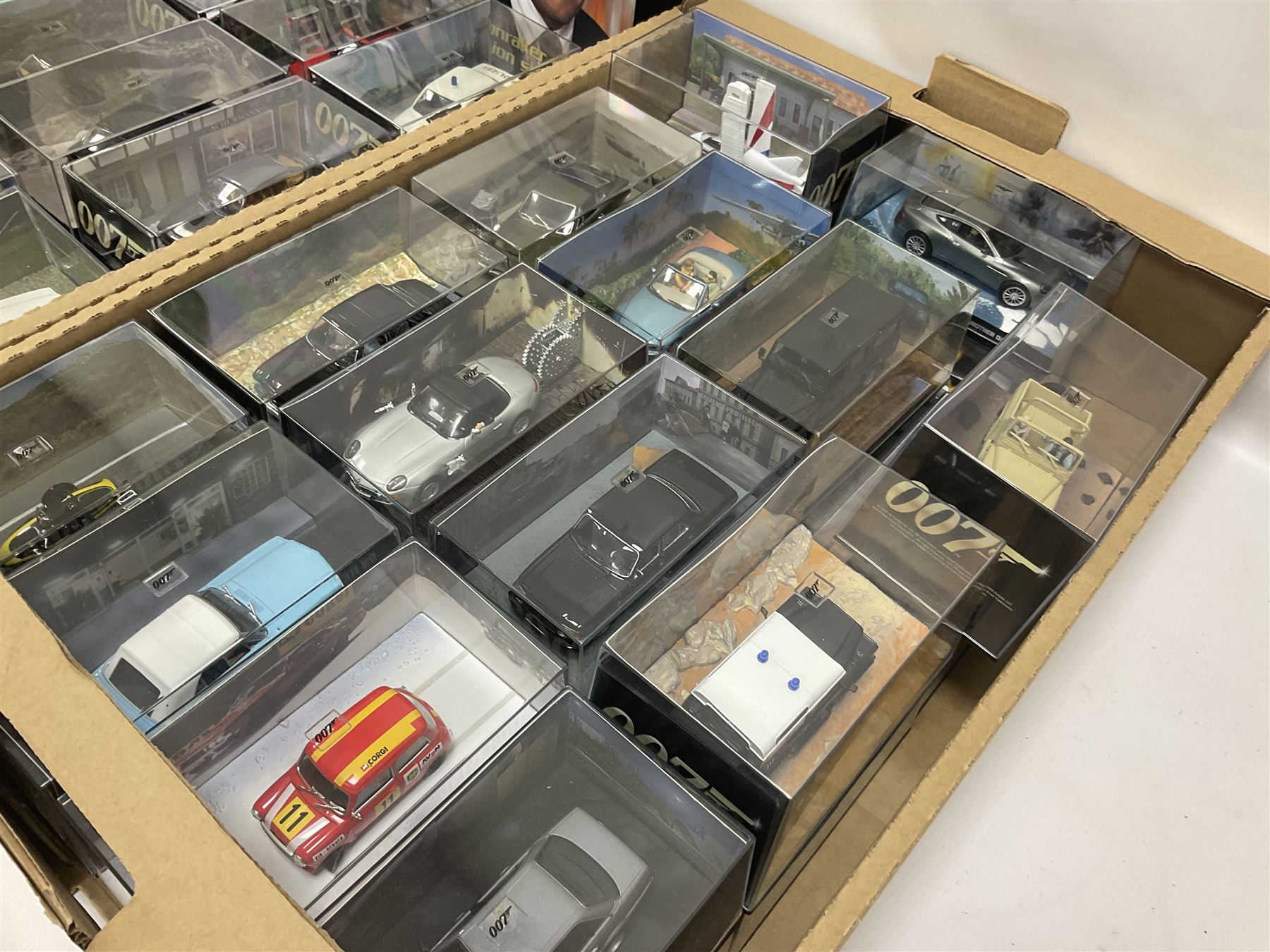 Fabbri James Bond Collection - over one hundred and ten die-cast models in perspex display cases as issued periodically; and a quantity of associated magazines and trading cards, in five boxes