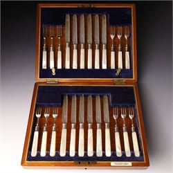 Set of twelve silver bladed fruit knives and forks with mother of pearl handles, the blade...