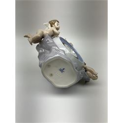 A Lladro mantel clock modelled as a globe with inset clock, surmounted by four putti and floral garlands, with blue printed mark and impressed 5973 beneath, H29cm.