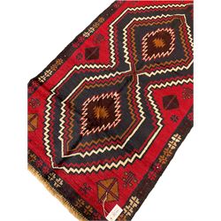 Baluchi red and blue ground rug decorated with two geometric lozenges and a repeating border