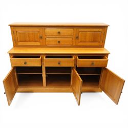 Knightman - Yorkshire oak dresser, the upper section fitted with two drawers flanked by two hutch cupboards, rectangular top over three drawers and fielded panelled cupboard, on skirted base, carved with knight signature, by Horcace Knight of Thirsk